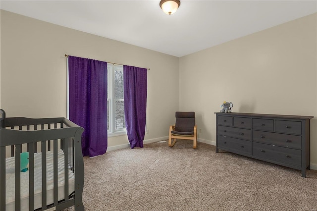 carpeted bedroom featuring a crib