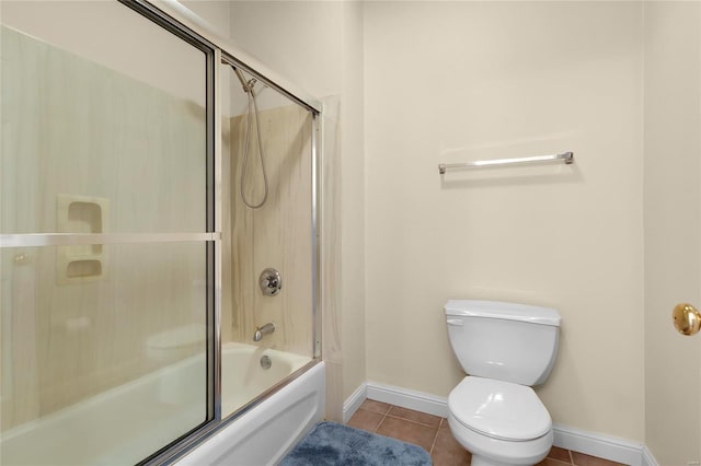 bathroom with toilet, bath / shower combo with glass door, and tile patterned floors