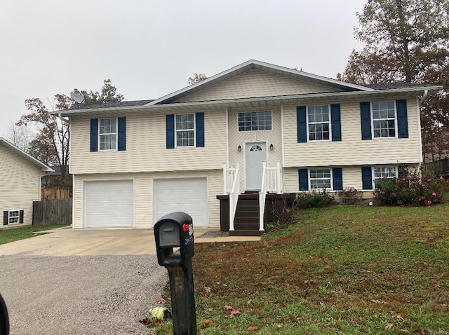 bi-level home with a garage and a front lawn