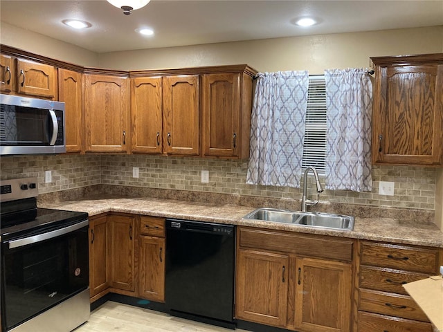 kitchen featuring tasteful backsplash, sink, and appliances with stainless steel finishes