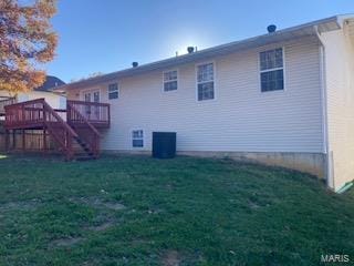 rear view of property with a wooden deck, a yard, and central AC unit