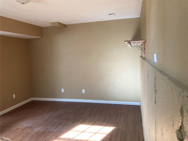 unfurnished room with dark hardwood / wood-style flooring