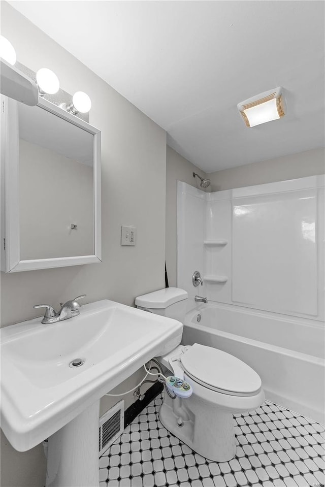 bathroom featuring toilet and shower / washtub combination