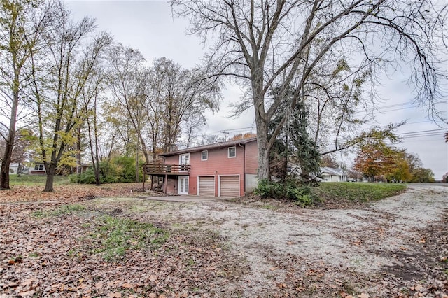 back of house with a deck