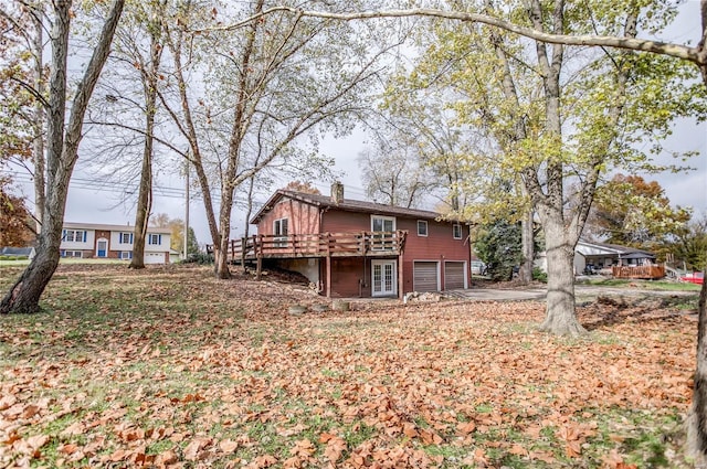 rear view of house featuring a wooden deck