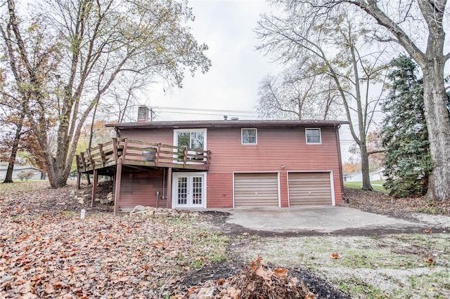 view of front of home with french doors, a garage, and a deck