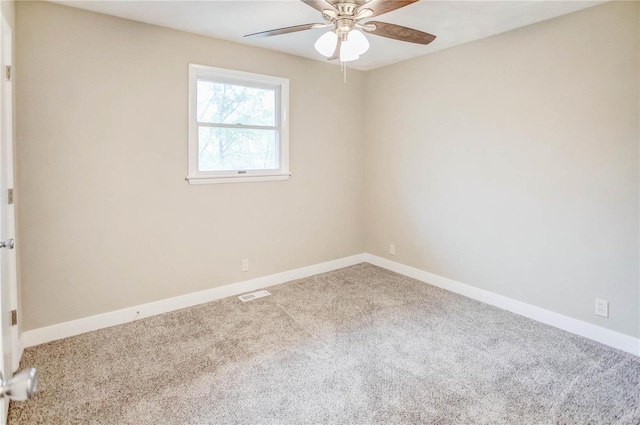 empty room with ceiling fan and carpet floors