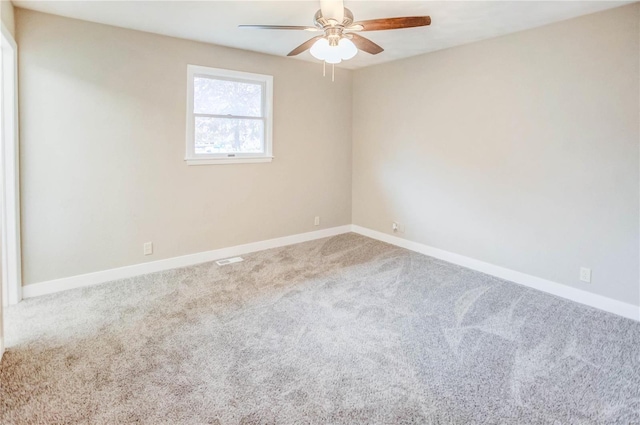 empty room with ceiling fan and carpet