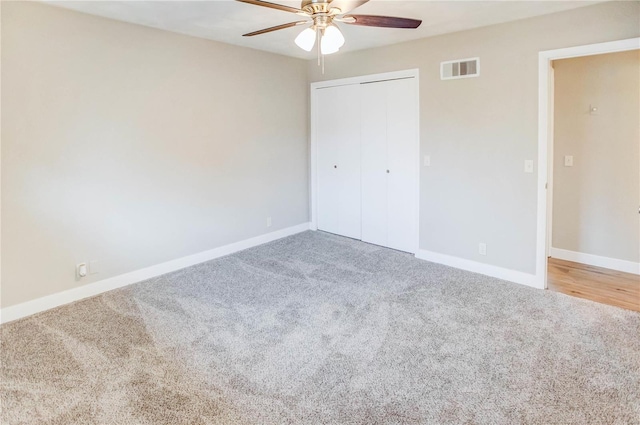 unfurnished bedroom with ceiling fan, a closet, and carpet floors