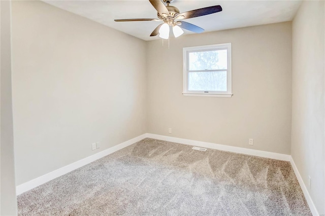 spare room featuring ceiling fan and carpet floors