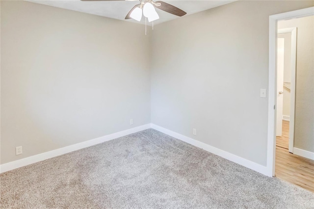 carpeted spare room with ceiling fan