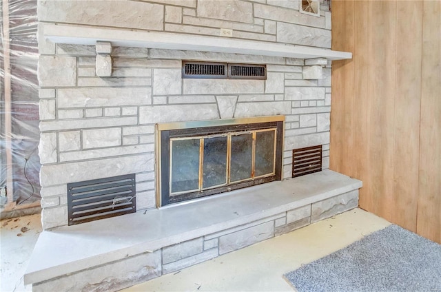 room details featuring a fireplace and concrete floors