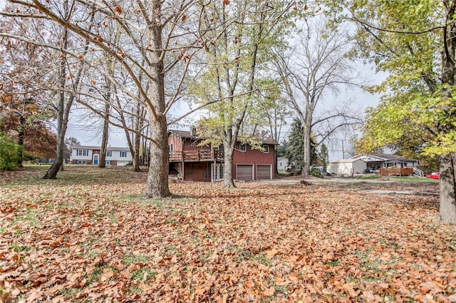 view of yard featuring a wooden deck and a garage