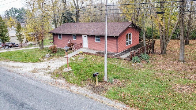 view of front of home featuring a front yard and a deck