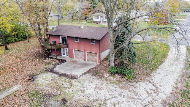 view of front of home with a garage and a wooden deck