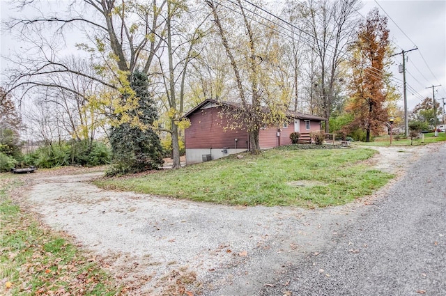 view of property exterior with a lawn