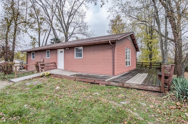 rear view of property with a wooden deck