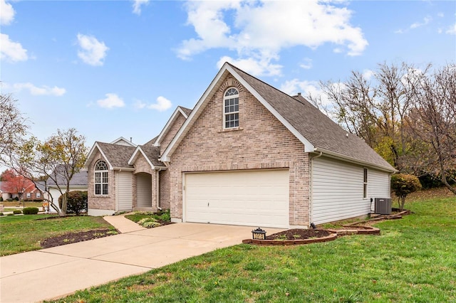 view of property featuring a front lawn, a garage, and central AC unit