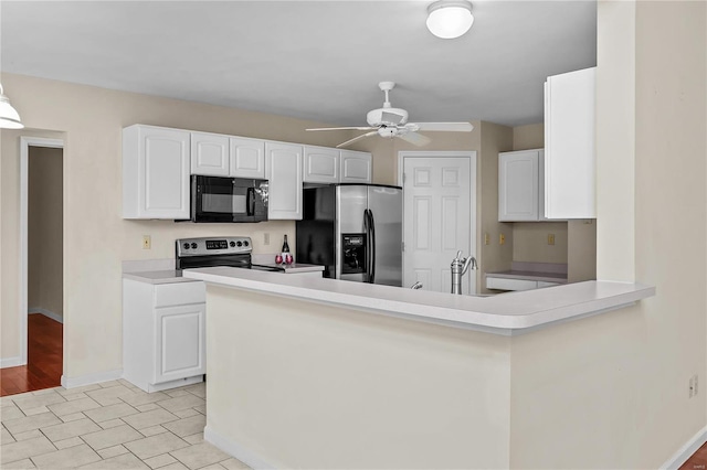 kitchen featuring white cabinets, appliances with stainless steel finishes, kitchen peninsula, and ceiling fan