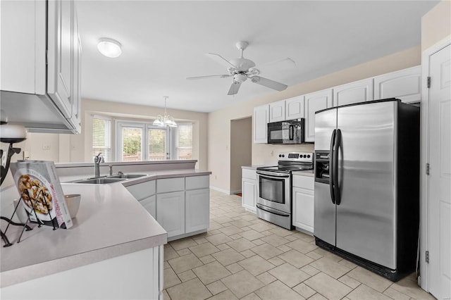 kitchen featuring white cabinets, appliances with stainless steel finishes, decorative light fixtures, and sink