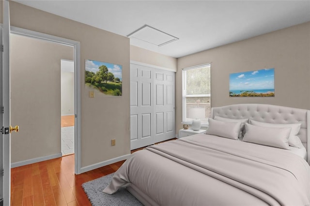 bedroom with hardwood / wood-style flooring and a closet