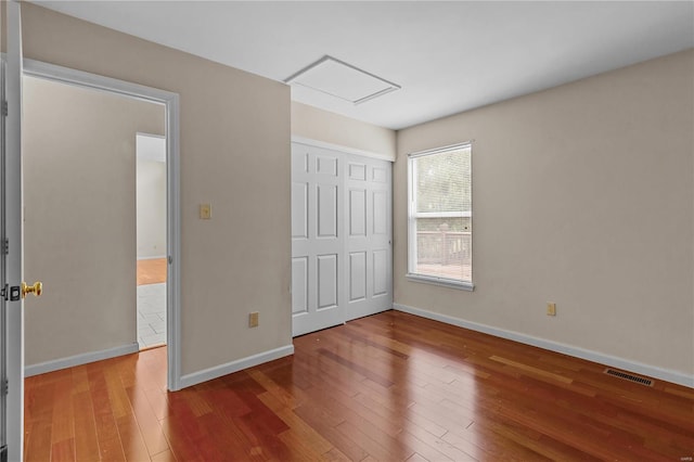 unfurnished bedroom featuring a closet and wood-type flooring