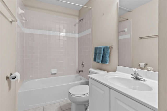 full bathroom featuring toilet, vanity, tile patterned floors, and tiled shower / bath