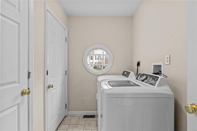 washroom featuring light tile patterned floors and independent washer and dryer