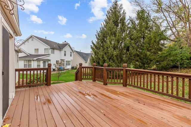 wooden terrace featuring a yard