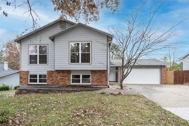 split level home with a garage and a front yard