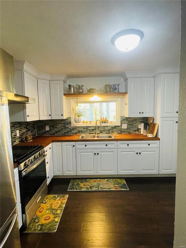 kitchen with stainless steel appliances, white cabinetry, and sink