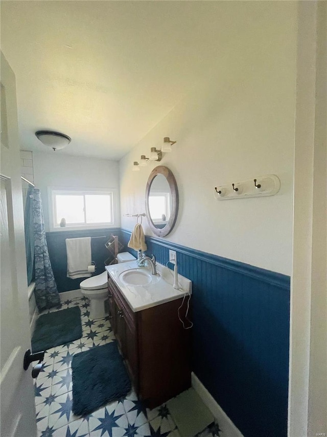 full bathroom with vanity, shower / bath combination with curtain, and toilet