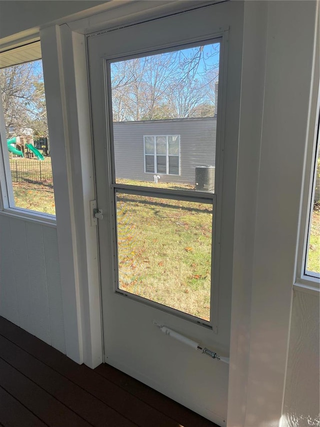 doorway to outside with hardwood / wood-style flooring and a healthy amount of sunlight