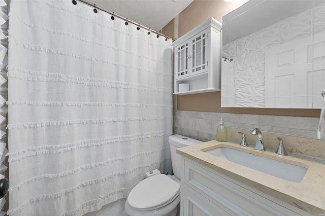 bathroom featuring toilet, tile walls, and vanity