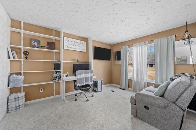 office space featuring carpet floors, baseboards, and a textured ceiling