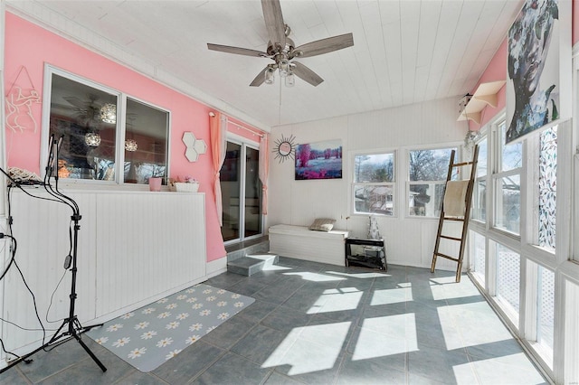 sunroom featuring a ceiling fan