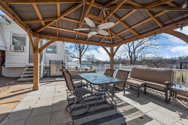 view of patio / terrace featuring entry steps, a ceiling fan, grilling area, fence, and a gazebo