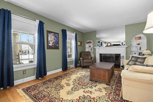 living room featuring light hardwood / wood-style floors and built in features