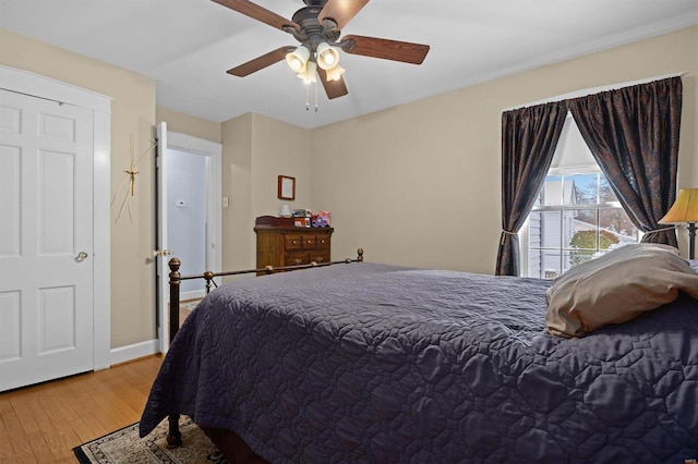 bedroom with ceiling fan and light hardwood / wood-style floors