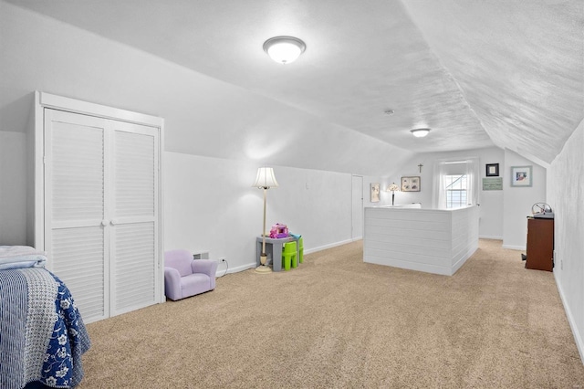 carpeted bedroom featuring a textured ceiling, a closet, and vaulted ceiling