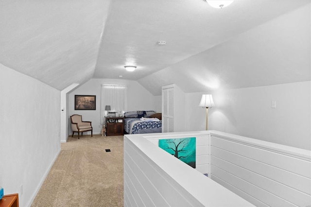 carpeted bedroom with lofted ceiling