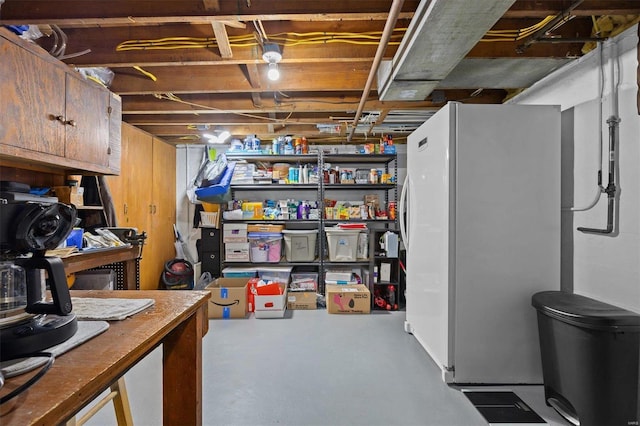 basement with white refrigerator