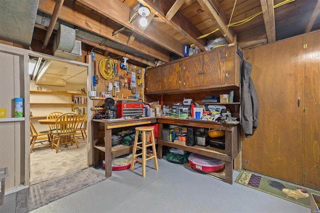 basement featuring a workshop area and wooden walls