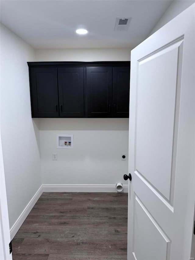 laundry area with dark wood-type flooring, washer hookup, visible vents, and baseboards