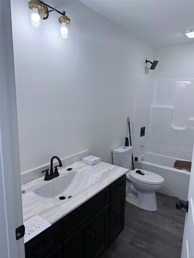 full bathroom featuring shower / bath combination, toilet, wood finished floors, and vanity