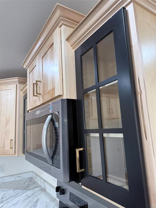 laundry room with cabinet space and a textured ceiling