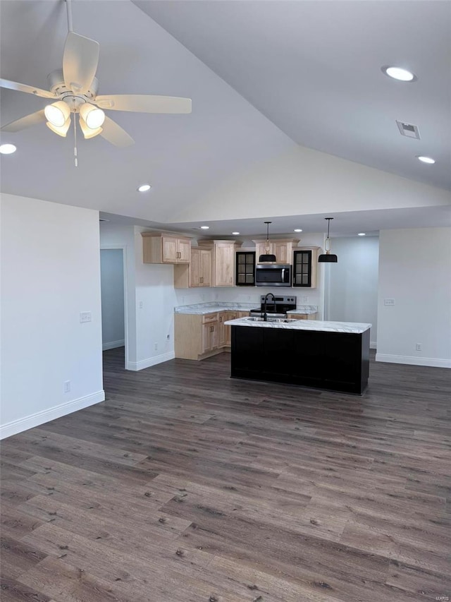 kitchen featuring stainless steel microwave, visible vents, open floor plan, a kitchen island with sink, and a sink