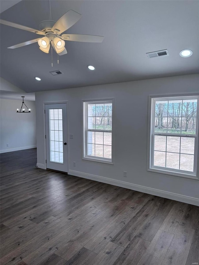 interior space featuring dark wood-style floors, visible vents, ceiling fan, and baseboards