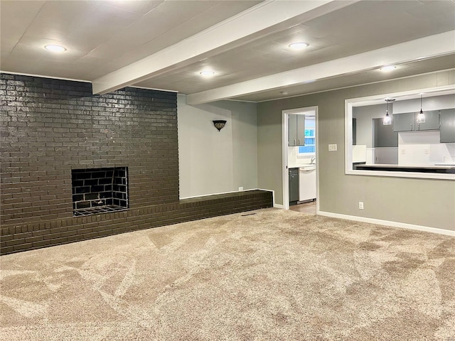 basement featuring carpet, brick wall, and a brick fireplace