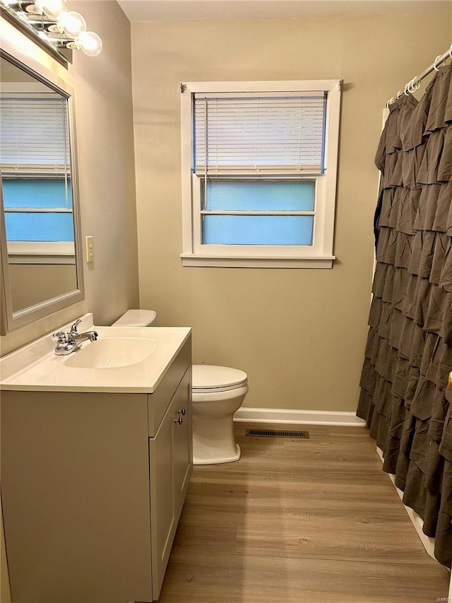 bathroom featuring hardwood / wood-style floors, vanity, and toilet